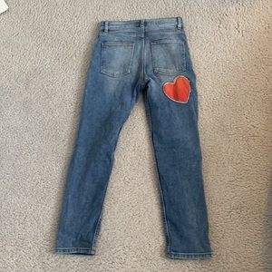 Revice Jeans with a red zipper and heart patch